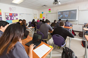Students working with TEALS volunteers via video conference