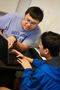 Photo of TEALS volunteer and student